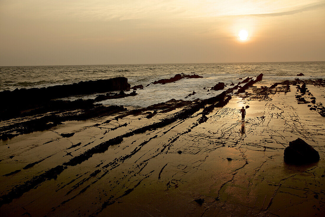 Mann am Strand im Sonnenuntergang, Jakarta, Java, Indonesien