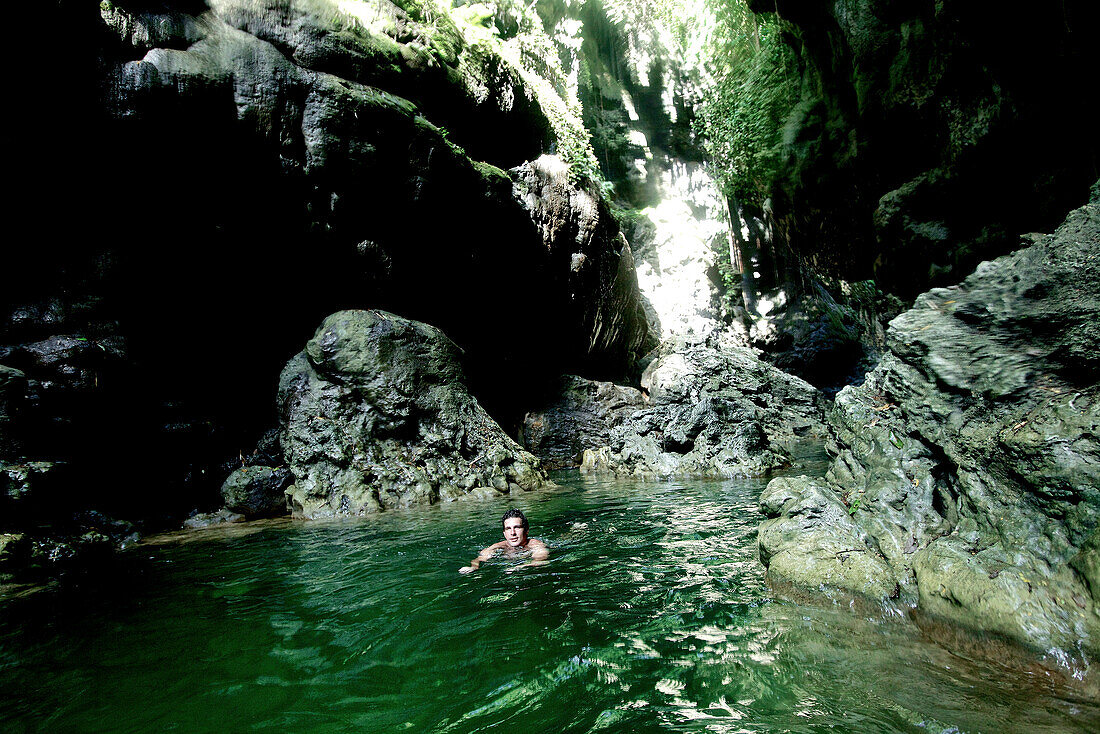 Man bathing in a river, Denpasar, Bali, Indonesia