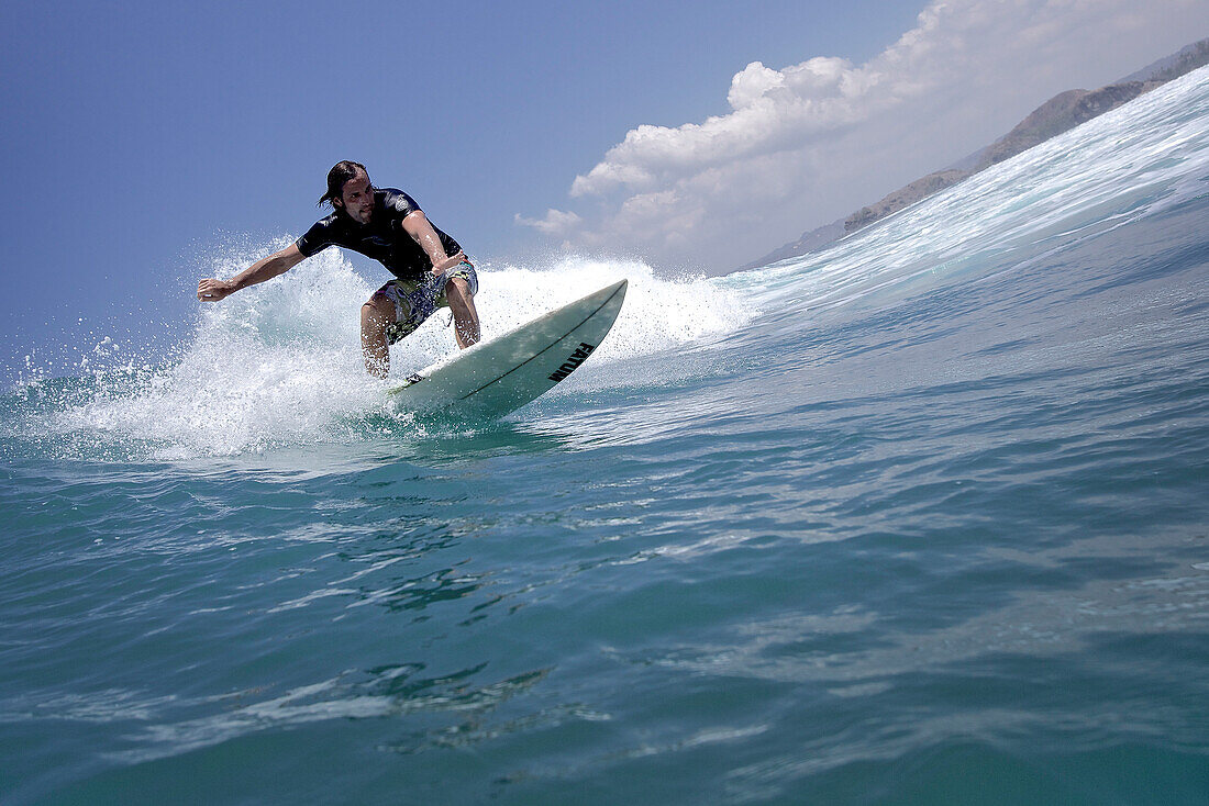 Surfer riding a wave, Jakarta, Java, Indonesia