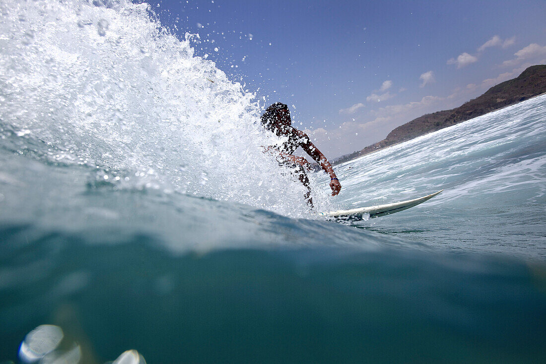 Surfer riding a wave, Jakarta, Java, Indonesia