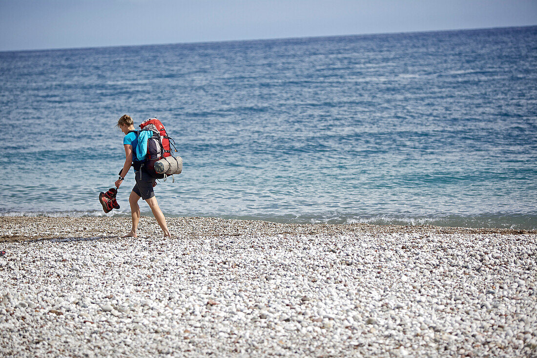 Woman hiking along long-distance footpath Lycian Way, Antalya, Turkey