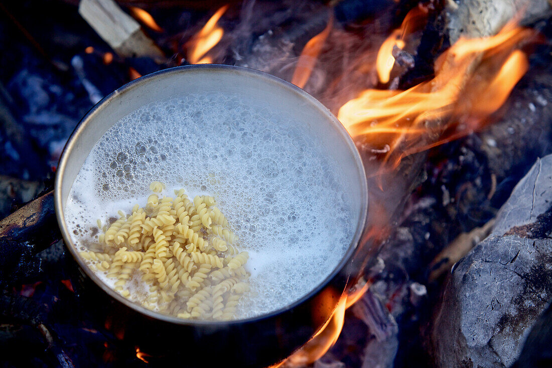 Cooking pasta above a campfire, long-distance footpath Lycian Way, Antalya, Turkey