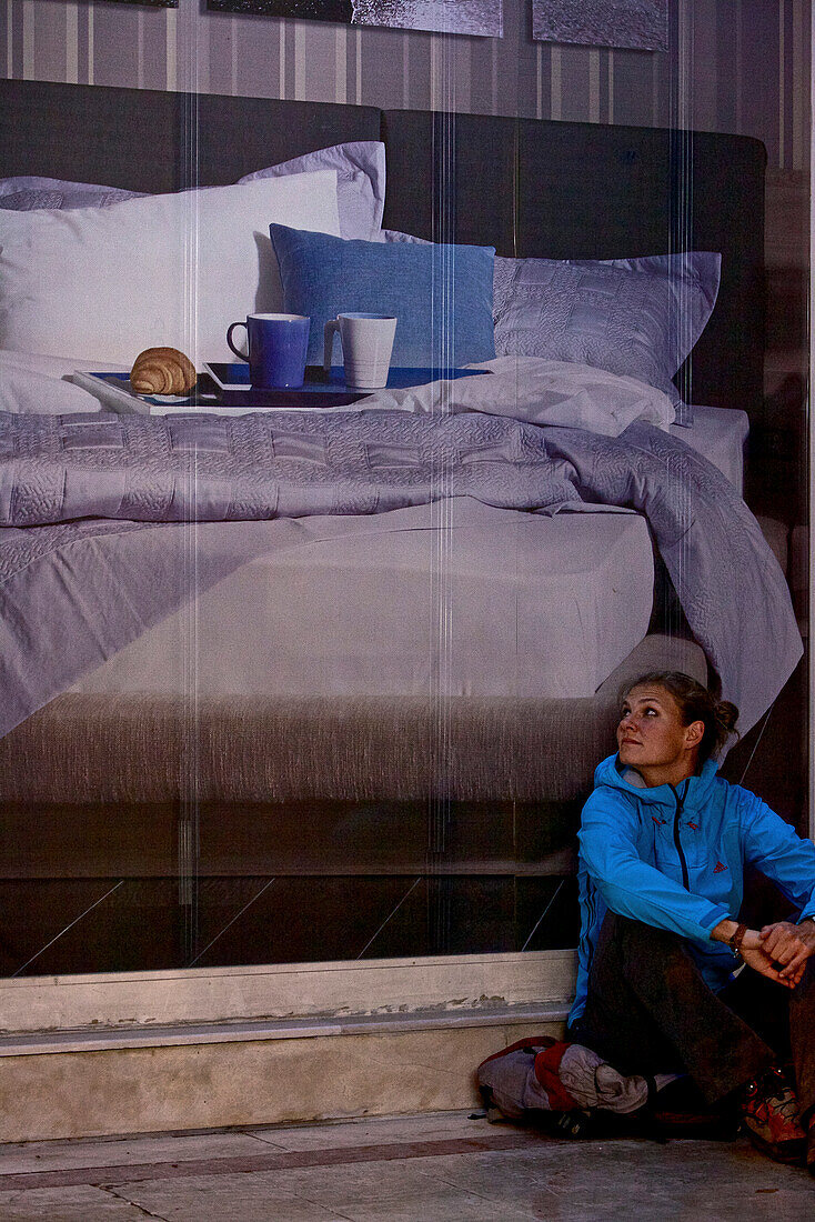 Woman leaning against a poster, long-distance footpath Lycian Way, Antalya, Turkey