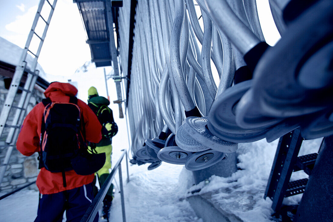 Two freeskiers waiting at a ski lift, Chandolin, Canton of Valais, Switzerland