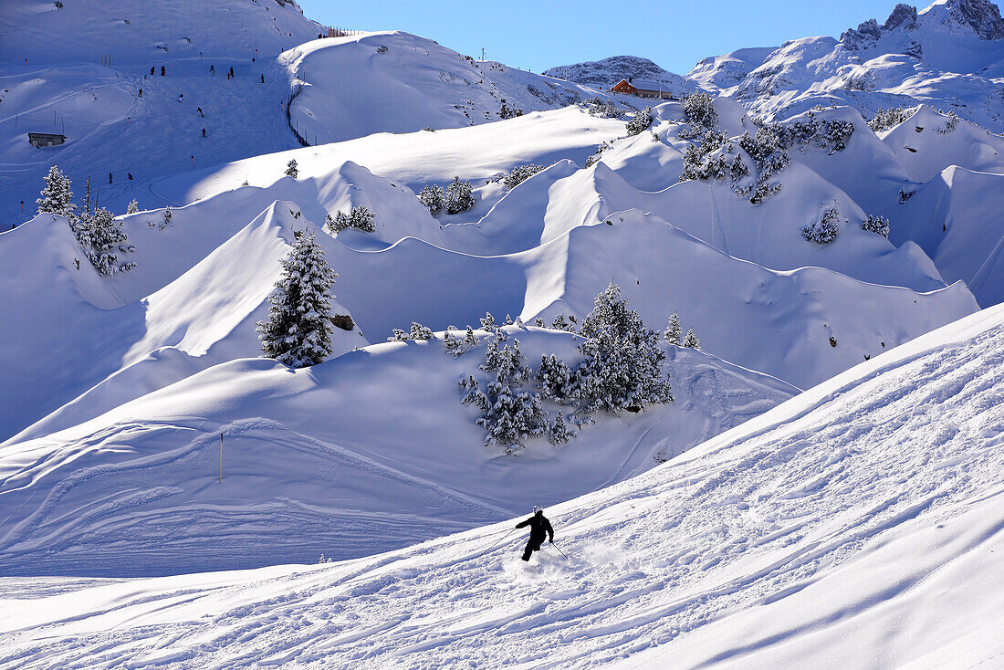 Person skiing in the skiing area with gypsum holes, Lech in Arlberg, Winter in Vorarlberg, Austria
