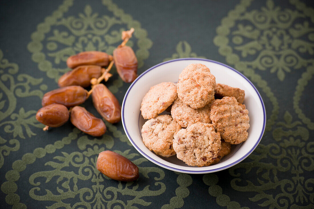 Dates and cookies, biscuits in a dish