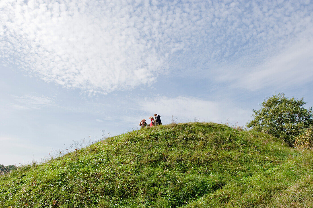 People on a grass-covered hill, Biebrza National Park, Podlaskie Voivodeship, Poland