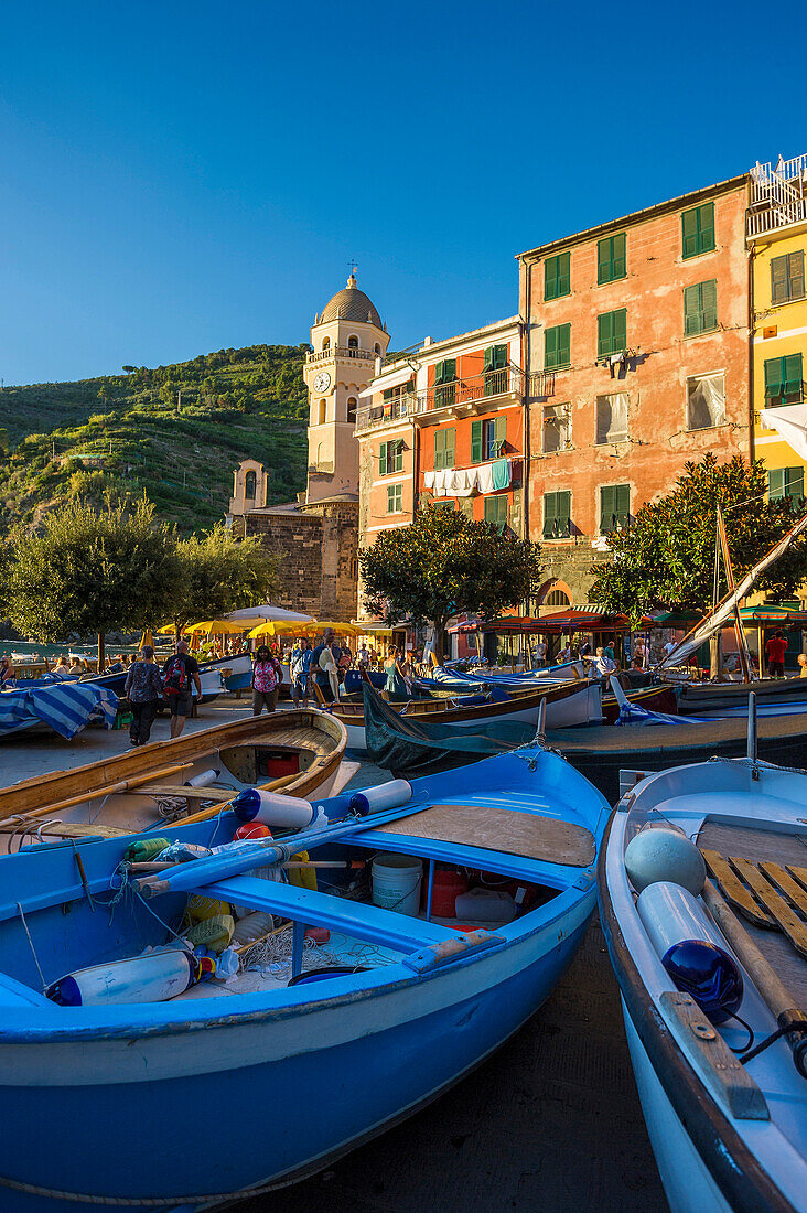 Fishing boats and Santa Margherita d Antiochia church in background, Vernazza, Cinque Terre, La Spezia, Liguria, Italy