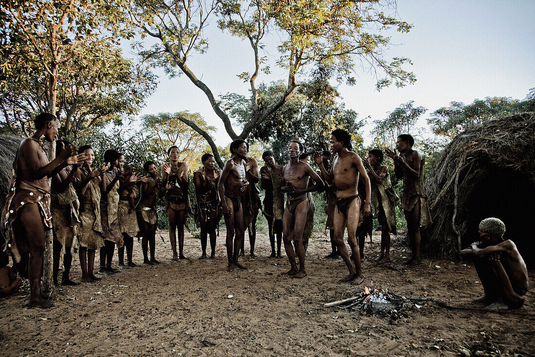 People of the San tribe dancing in their village around a fire, Otjozondjupa region, Namibia, Africa
