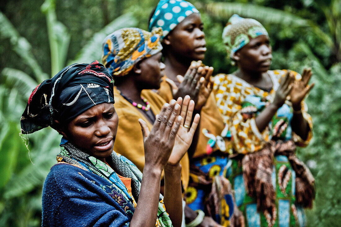 Women in a Pygmy village singing and clapping, Lake Bunyonyi, Uganda, Africa