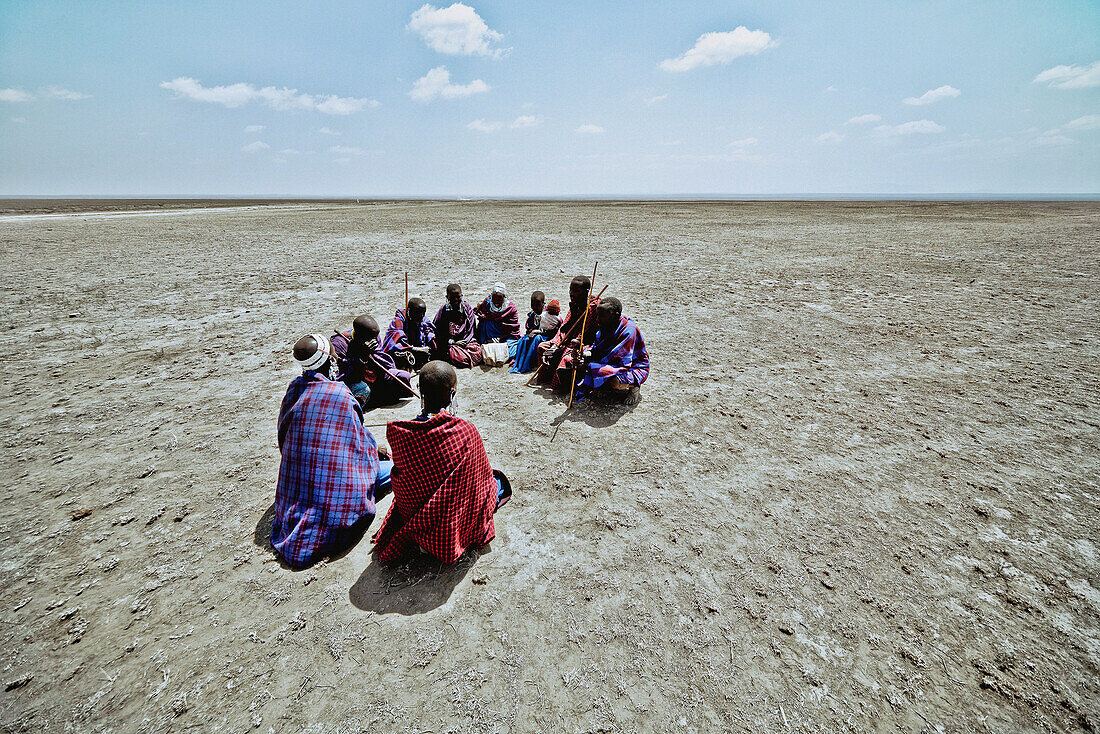 Massai's sitting in a circle in the plains, Ngorongoro, Tanzania, Africa