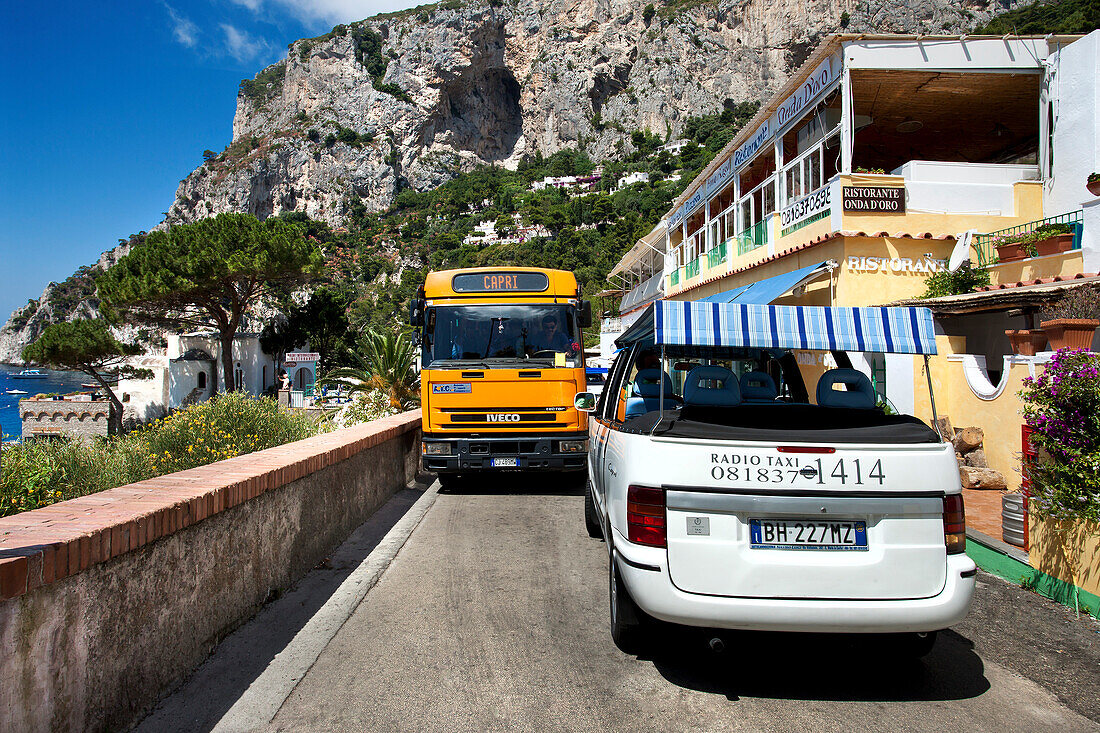 Bus und Taxi auf enger Straße, Capri, Kampanien, Italien