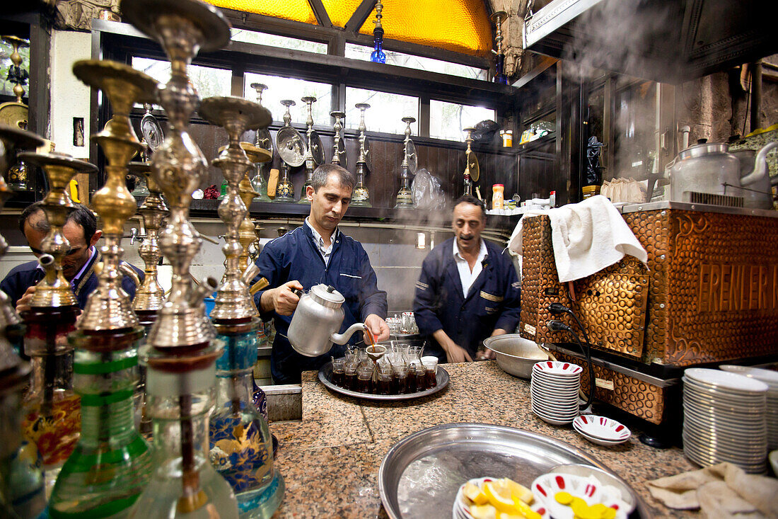 Waiter making tea and preparing hookahs in the teashop, Istanbul, Turkey
