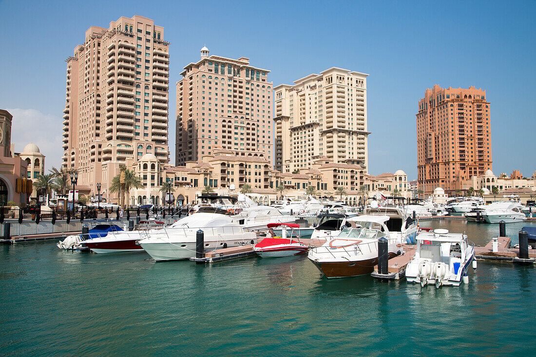 Luxury yachts berthed at Porto Arabia marina at The Pearl Qatar development, Doha, Qatar