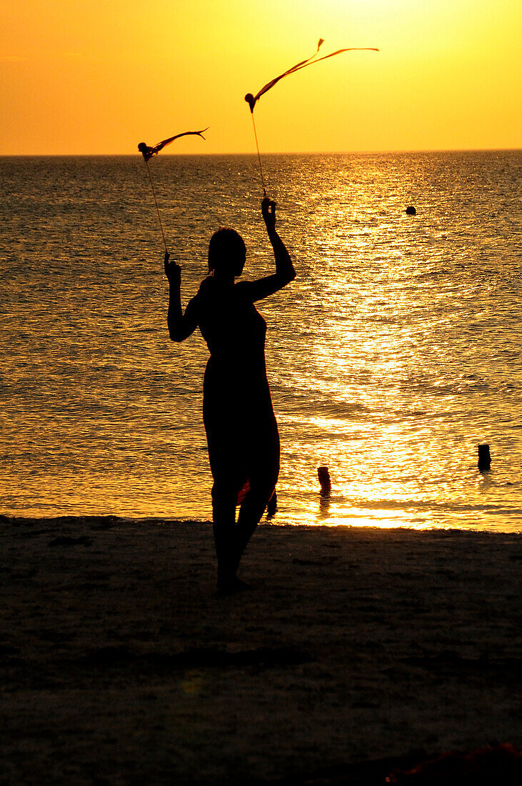 woman silhouetted evening sky, Holbox, Mexico