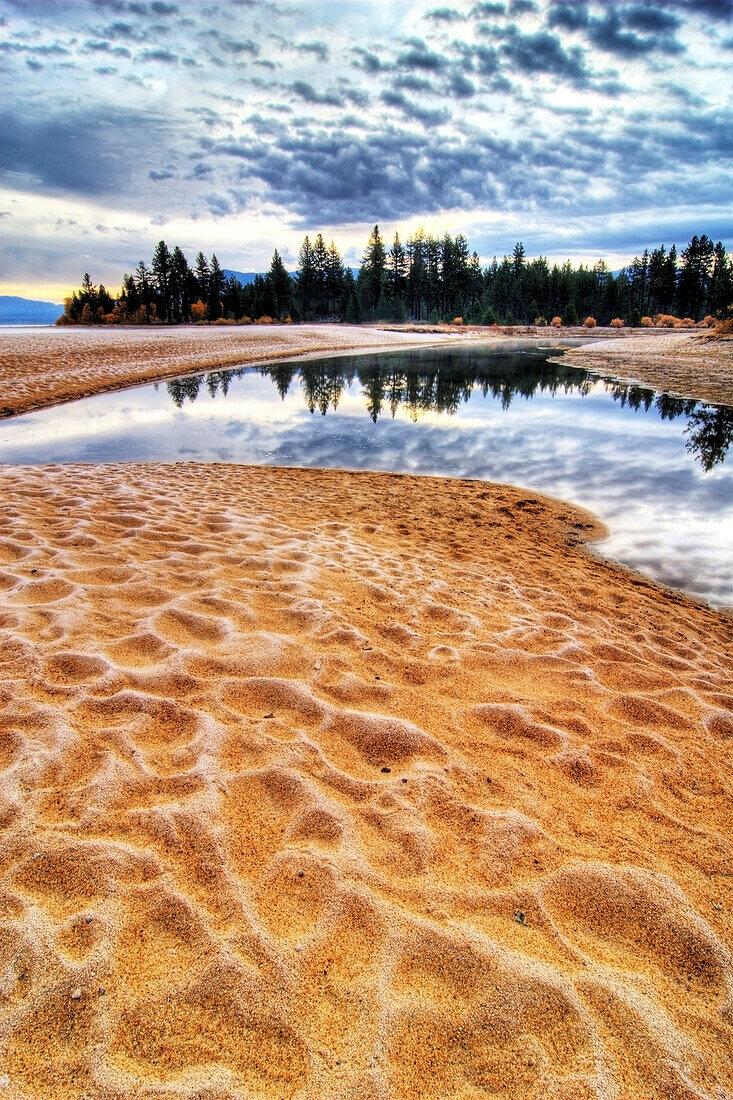 Sunrise with frost covered sand at Taylor Creek on the west shore of Lake Tahoe, CA Lake Tahoe, California, USA