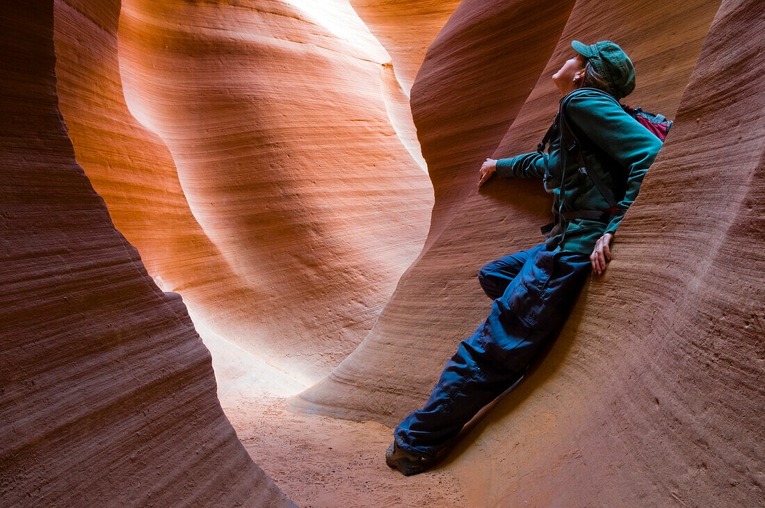 A female hiker takes a moment to enjoy Lower Antelope Canyon located outside of Page, AZ Lower Antelope Canyon, Arizona, USA