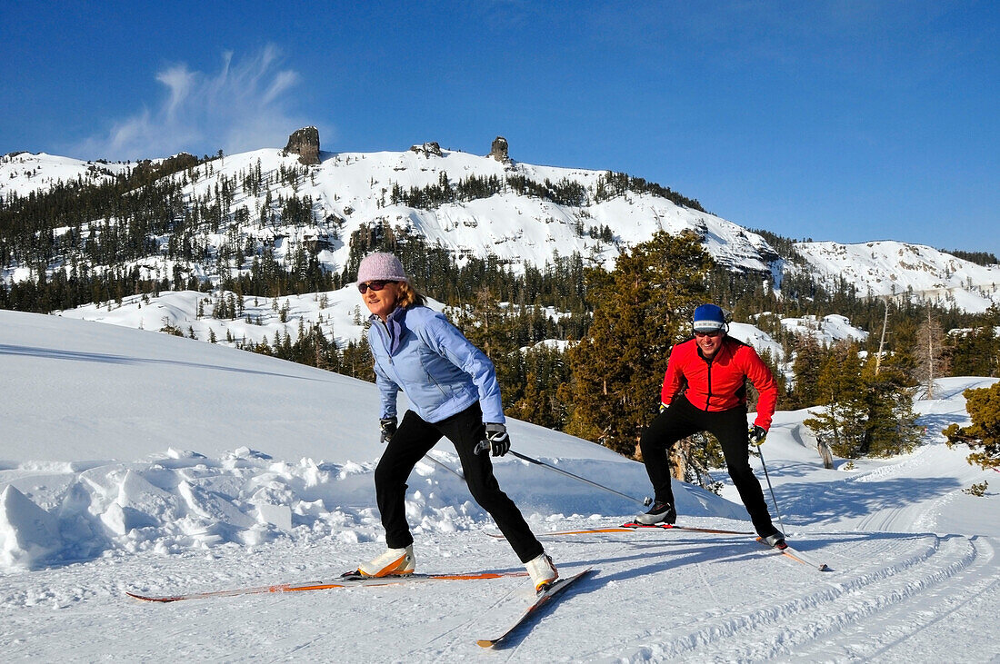 A man and woman cross country ski at Kirkwood Mountain Resort, California Kirkwood, California, USA