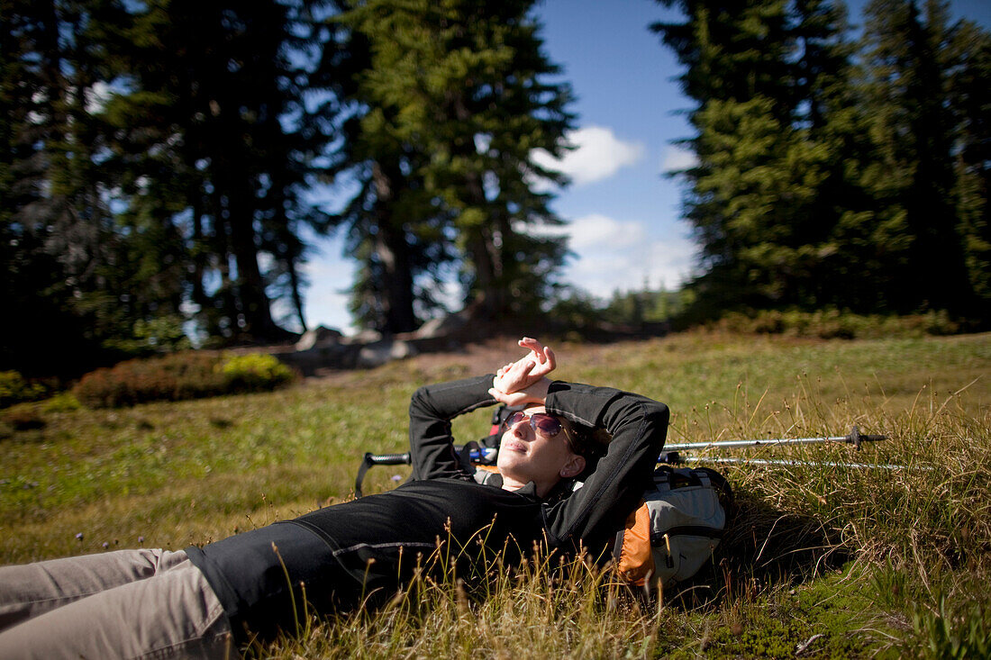 A young woman rests after hiking to Jefferson Park in the North Oregon Cascades in September, 2010 Oregon, USA