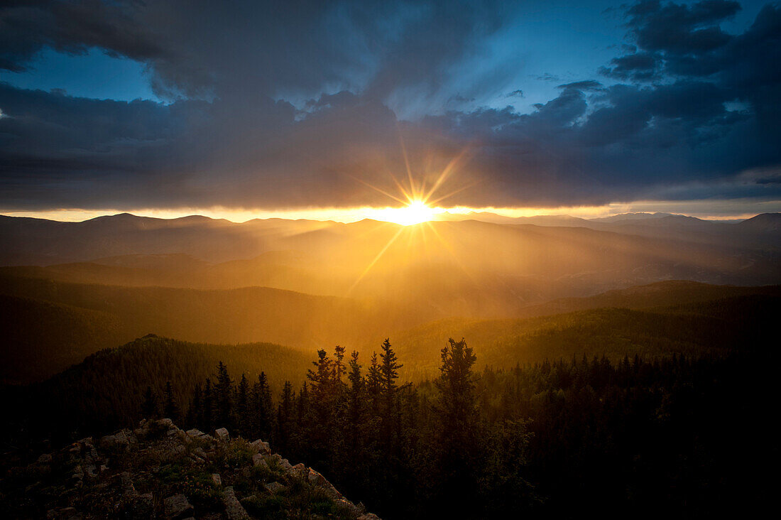 Setting sun lighting up rain in a mountain valley.  Cuchara, Colorado, United States Cuchara, Colorado, United States