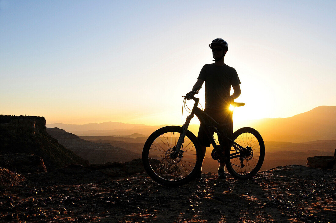 A silhouette of a mountain biker at sunset on Gooseberry Mesa in southern Utah Gooseberry Mesa, Utah, USA