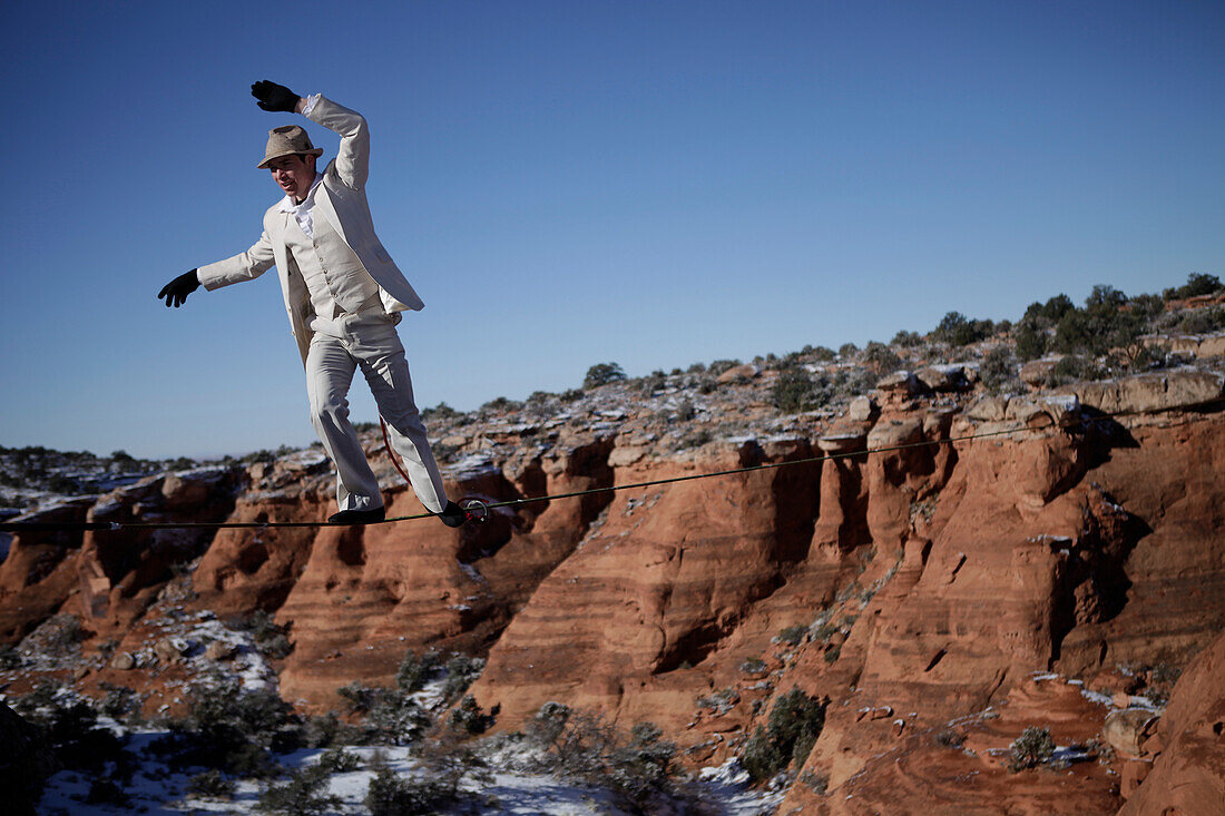 Male highliner in white pinned stripe suite, Moab, Utah, USA Moab, Utah, United States