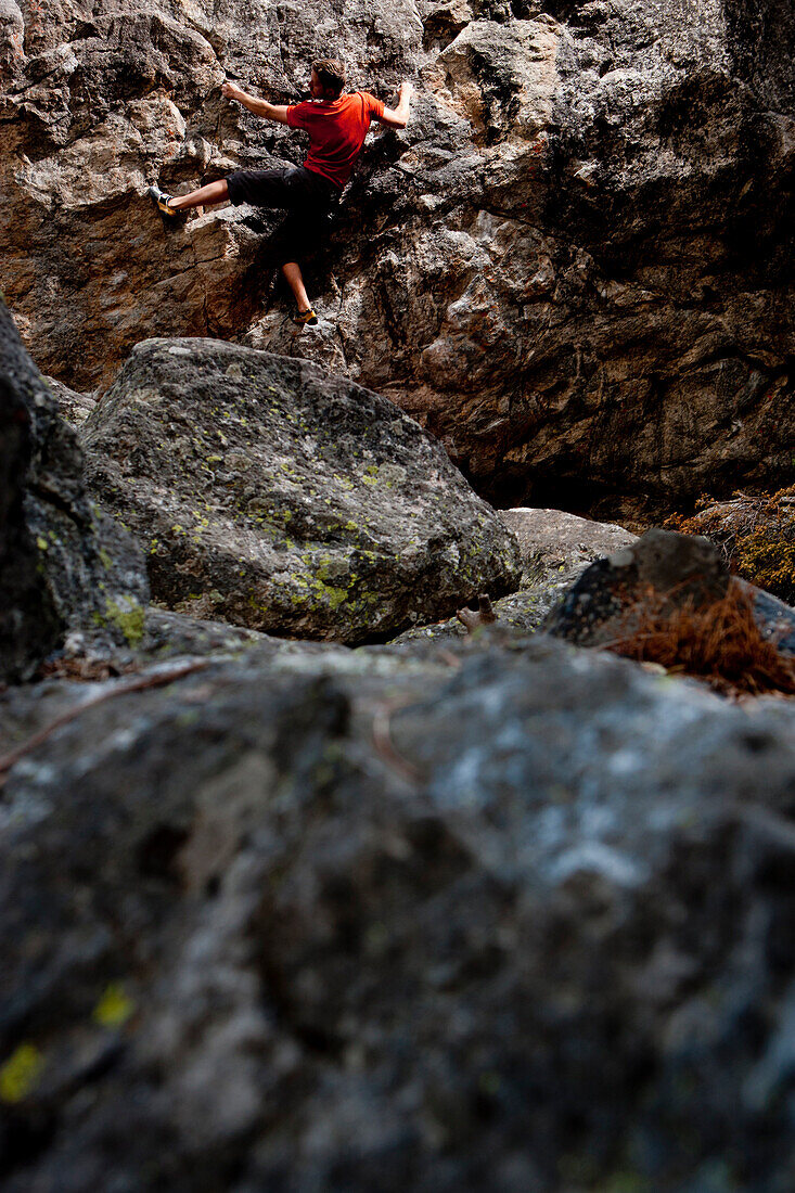 Male climber climbing a bouldering route Jackson Hole, Wyoming, USA