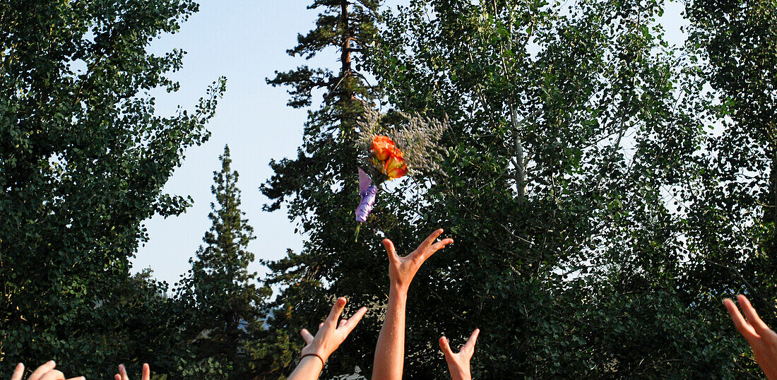 Ladies' hands reach for the bouquet in South Lake Tahoe, California Lake Tahoe, California, USA