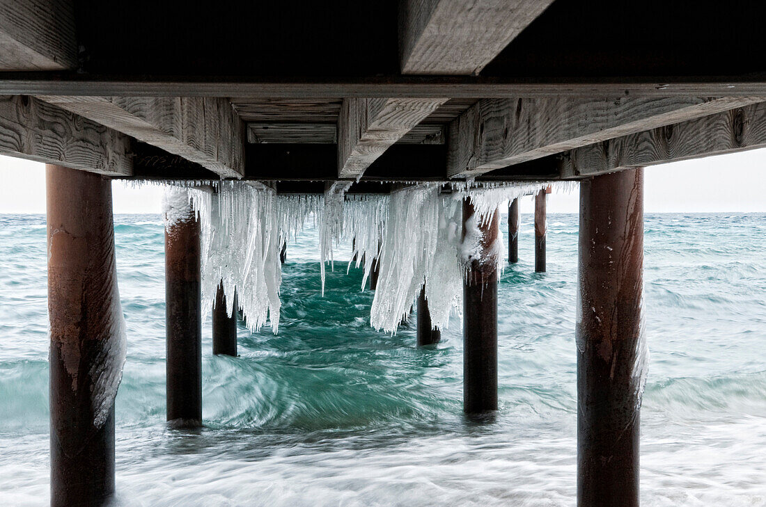 Ice hangs underneath a dock in Lake Tahoe, Nevada Incline Village, Nevada, USA