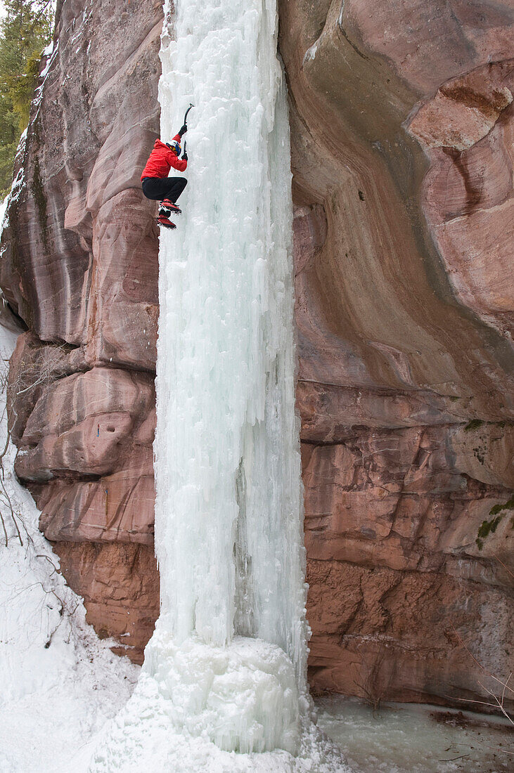 Man climbing ice pillar without a rope, Redstone, Colorado Redstone, Colorado, USA