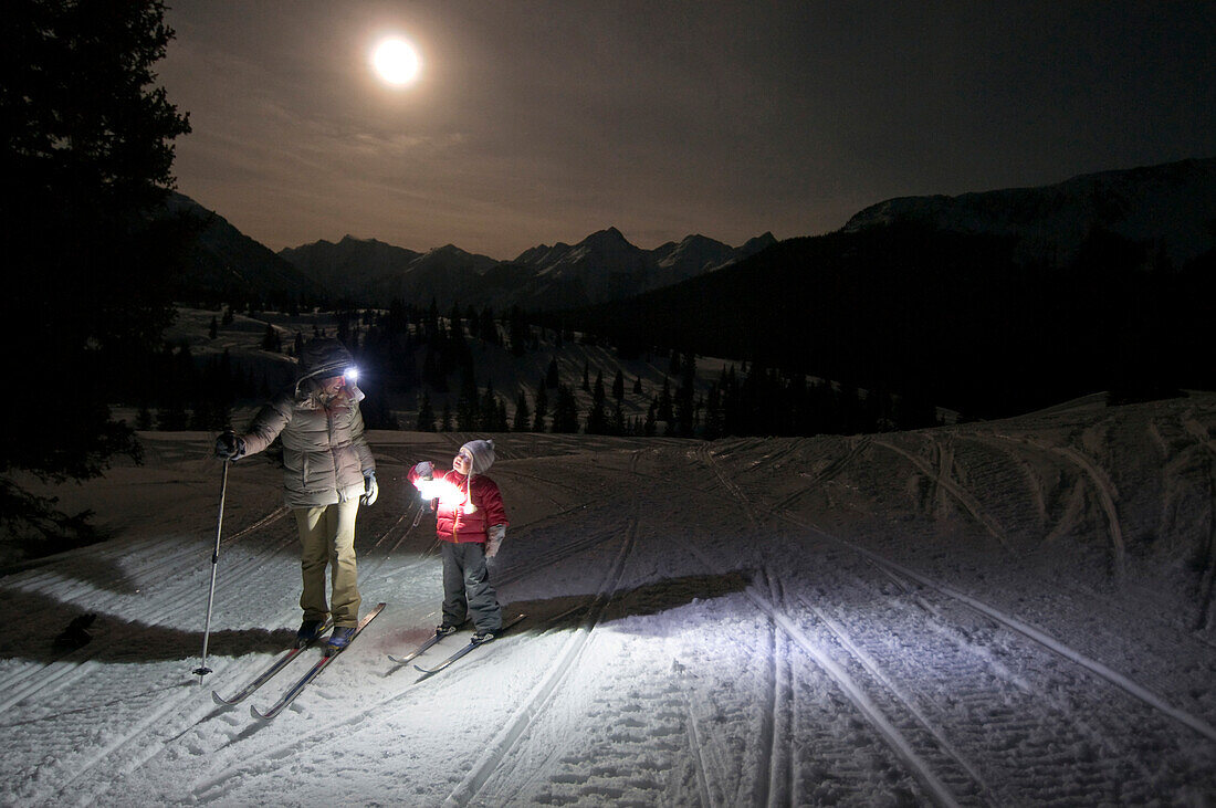 Mother and daughter on a nighttime cross country ski on Molas Pass, Silverton, Colorado Durango, Colorado, USA