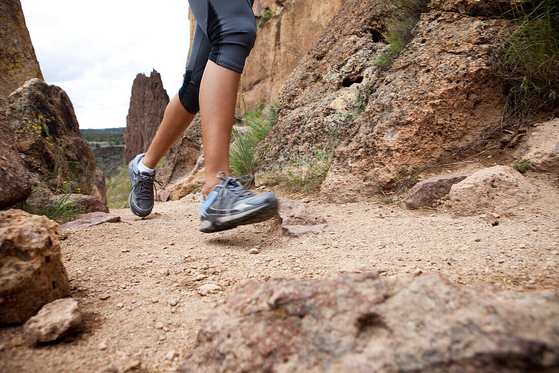 Female's legs trail running on dirt path Bend, Oregon, United States