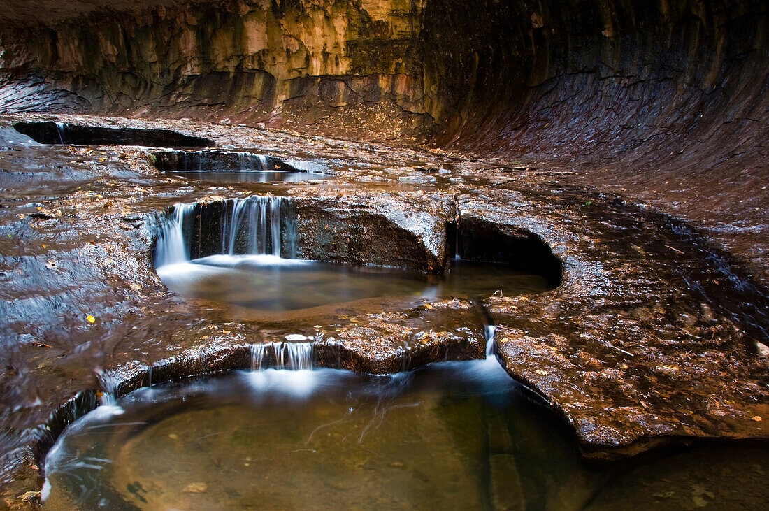 Dark pools of water cascade down the Subway Canyon in Zion National Park, Utah Zion National Park, Utah, USA