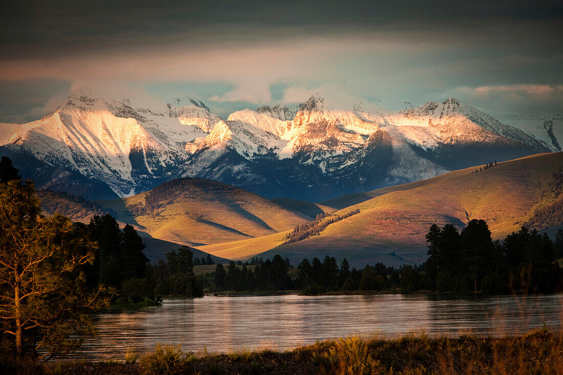 A beautiful river and mountain range at sunset in Montana Missoula, Montana, USA