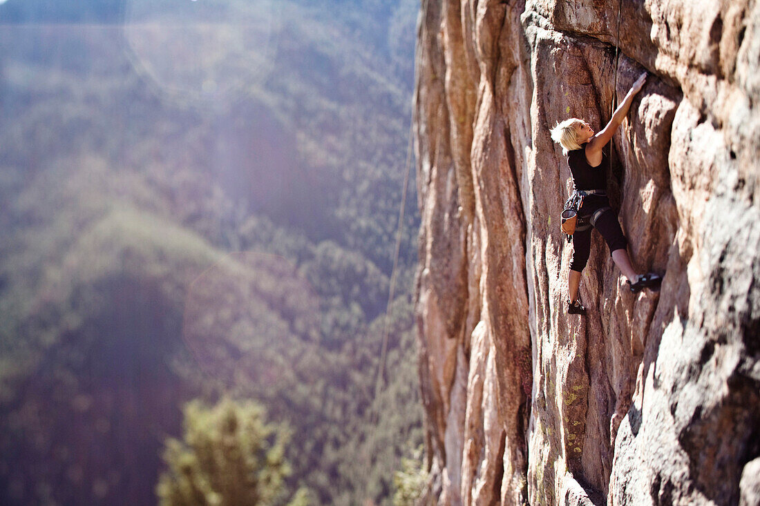 A athletic woman rock climbing near Bozeman, Montana., Bozeman, Montana, USA