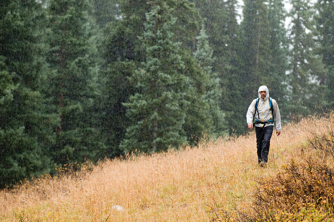 A man hiking in the rain on Molas Pass, San Juan National Forest, Silverton, Colorado.A man hiking in the rain on Molas Pass, San Juan National Forest, Silverton, Colorado., Silverton, Colorado, usa