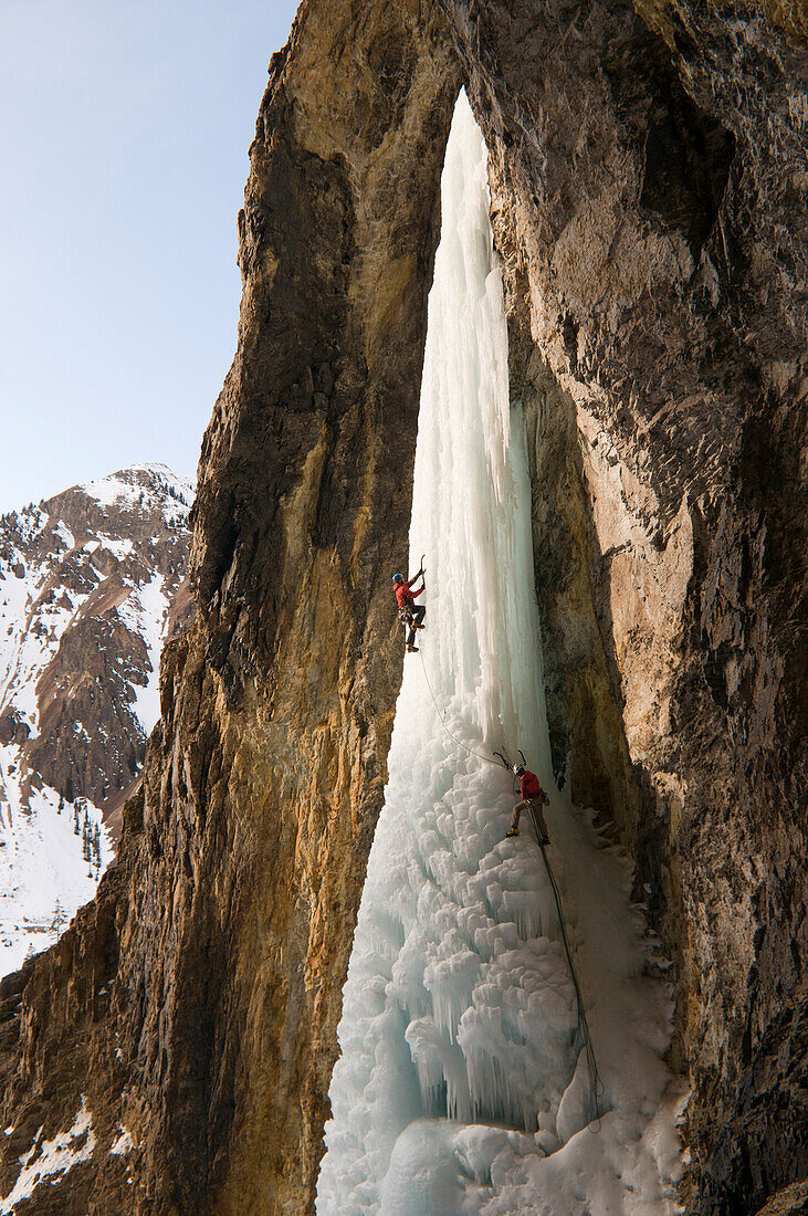A man and woman ice climbing a frozen waterfall, Silverton, Colorado., Silverton, Colorado, usa