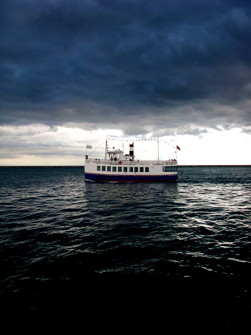 Scenic view in Chicago of a river boat out on Lake Michigan., Chicago, IL, USA