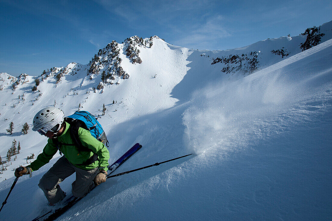 One female telemark skier making a hard turn., Ogden, Utah, USA