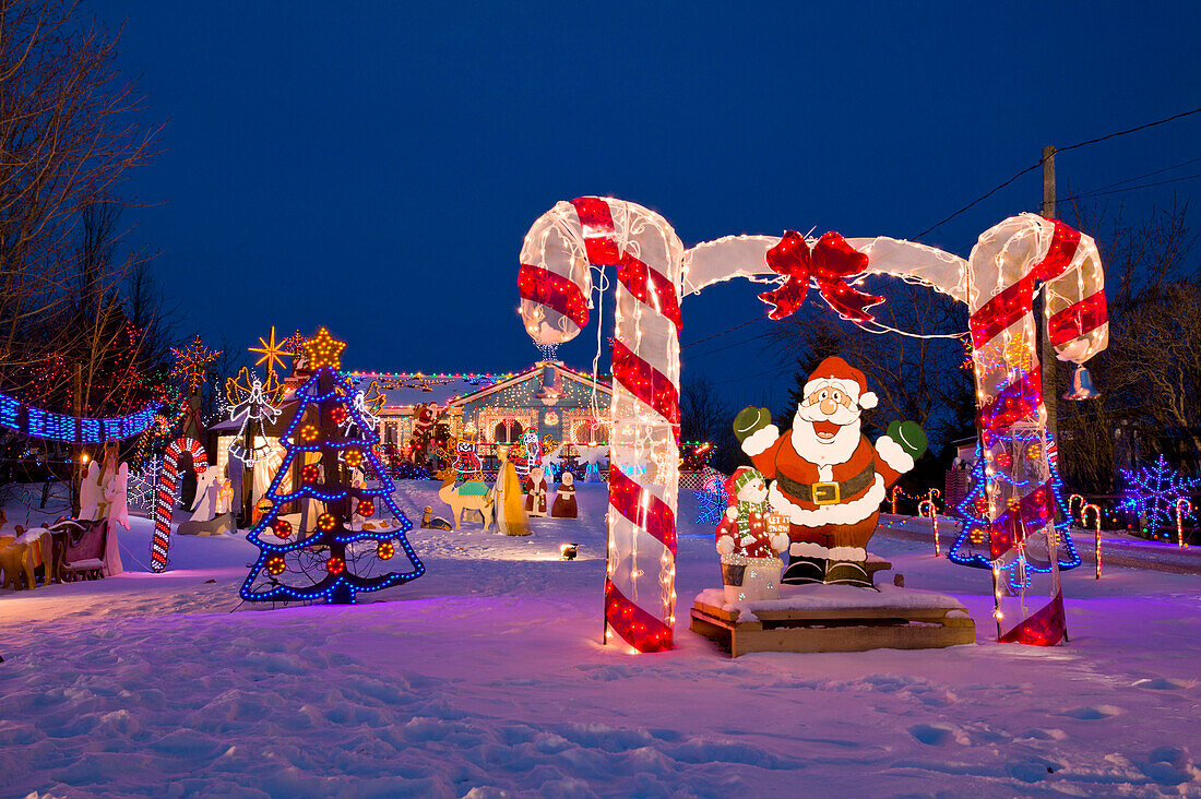 Santa Claus and other holiday decorations and lights in the snow in North Rustico, Prince Edward Island, Canada., North Rustico, PEI, Canada