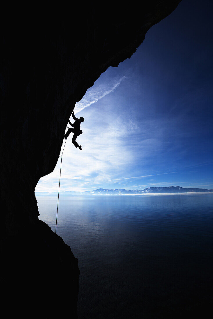 Man climbing against blue sky Lake Tahoe, Nevada, United States