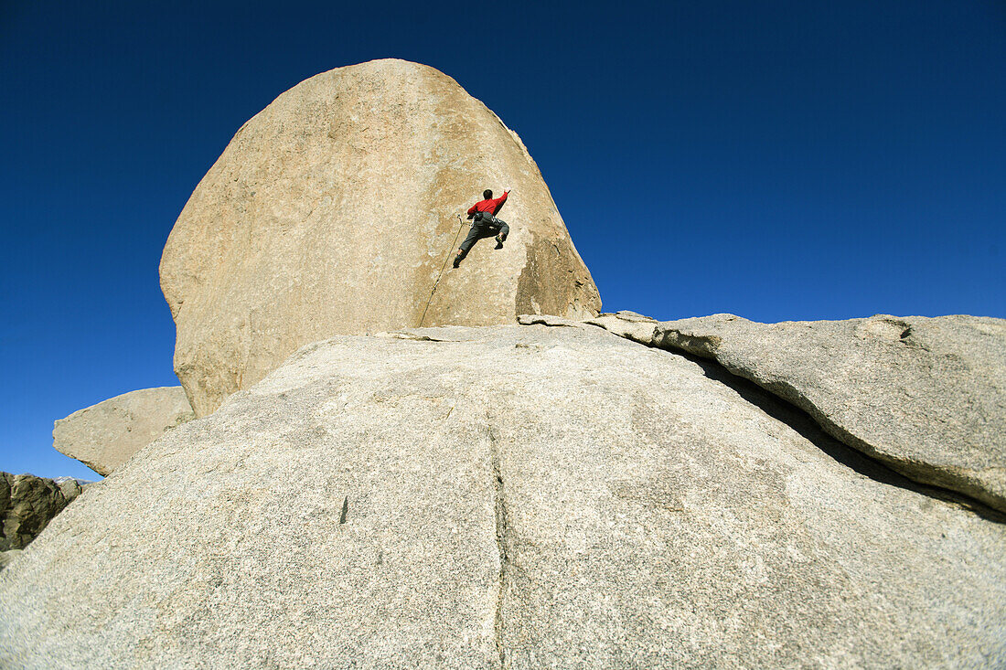 Male lead climbing on a boulder, Bishop, California, United States