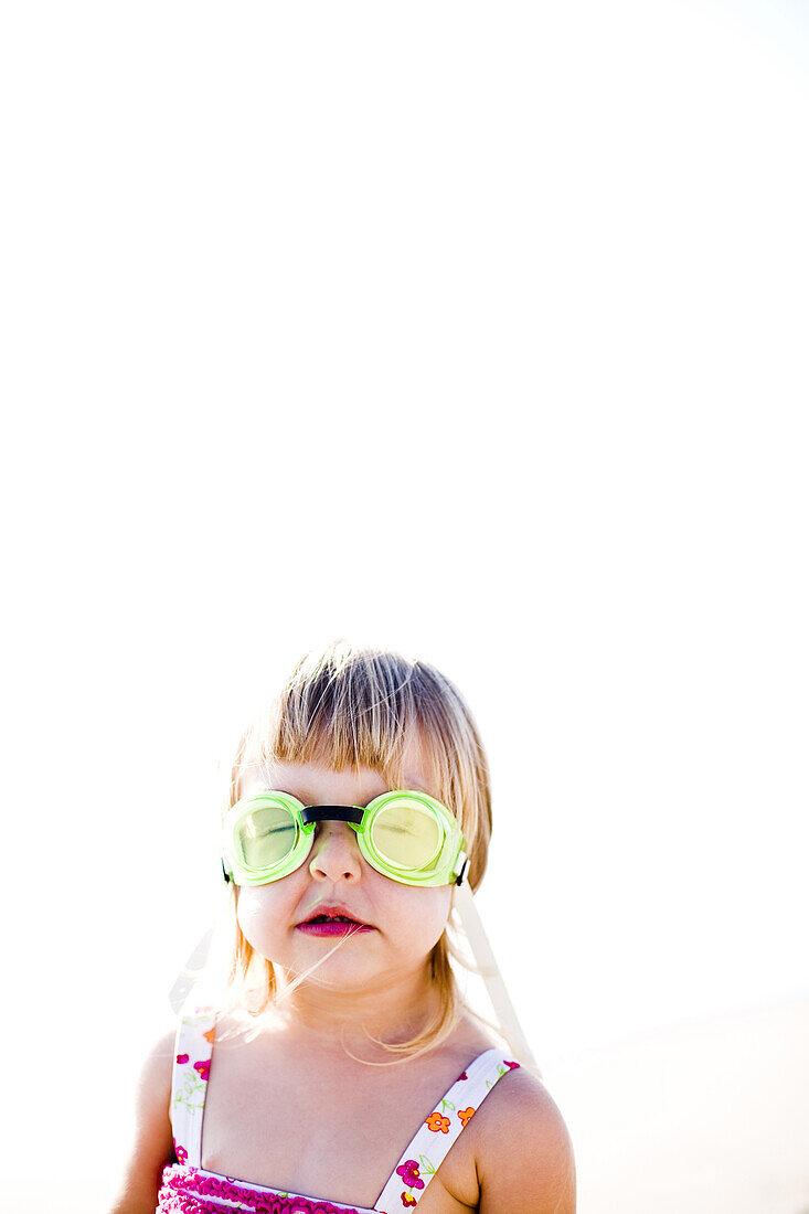 Little girl in bathing suits and goggles, Carlsbad, California, United States