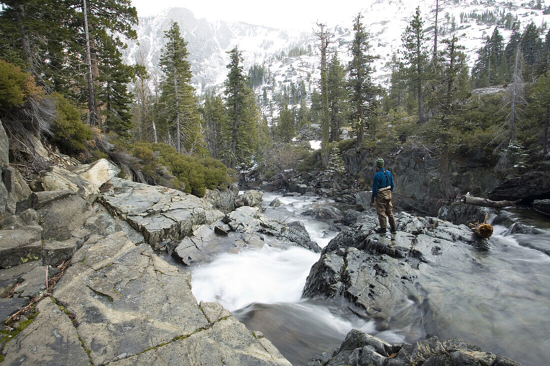 Fly fisherman on river in winter South Lake Tahoe, California, United States