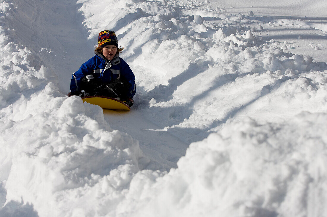 A young girl sledding, Newry, Maine Newry, Maine, USA