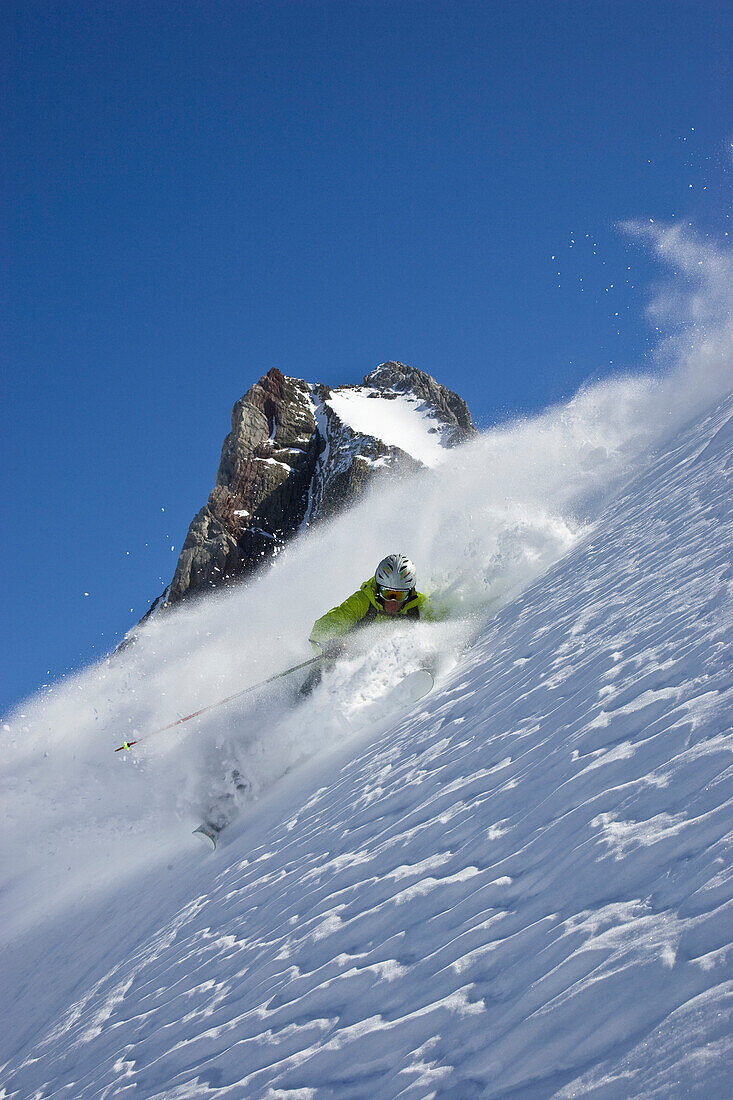 A young man skis untracked powder off-piste at St. Anton am Arlberg, Austria St. Anton am Arlberg, Arlberg, Austria