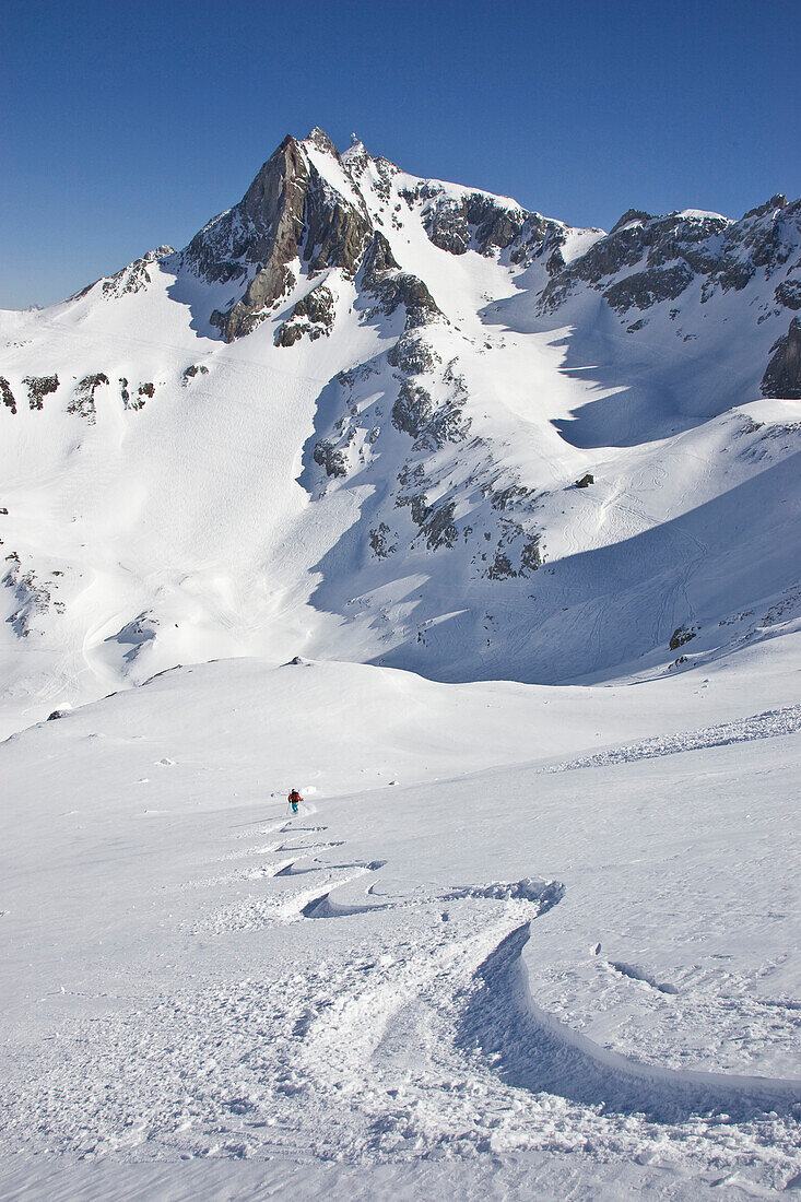 A young man skis untracked powder off-piste at St. Anton am Arlberg, Austria St. Anton am Arlberg, Arlberg, Austria