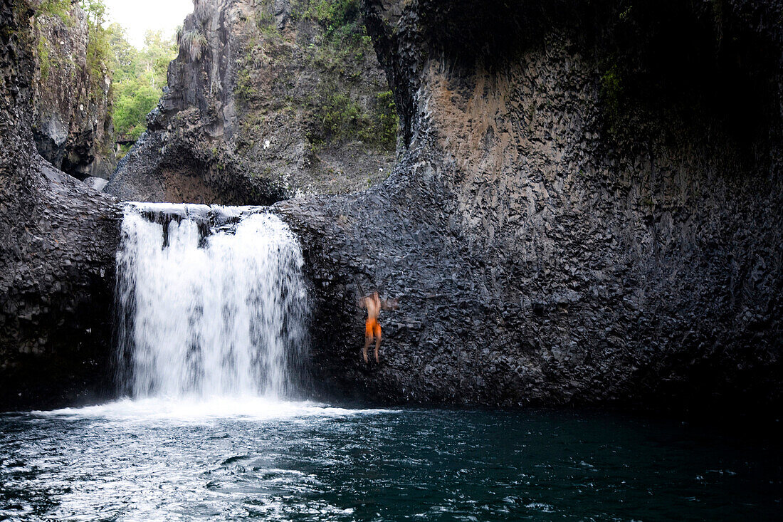 A young man jumps off one of the seven waterfalls that make up the Siete Tazas Chile