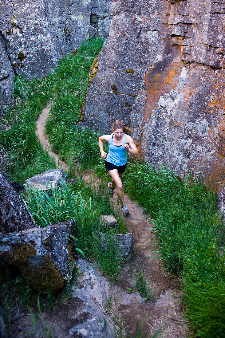 One woman running through Crack In the Ground, a volcanic fissure near Christmas Valley, Oregon Christmas Valley, Oregon, USA