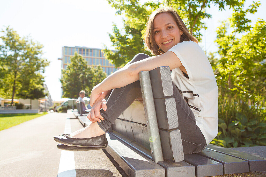 Woman sitting on a bench, Munich, Bavaria, Germany